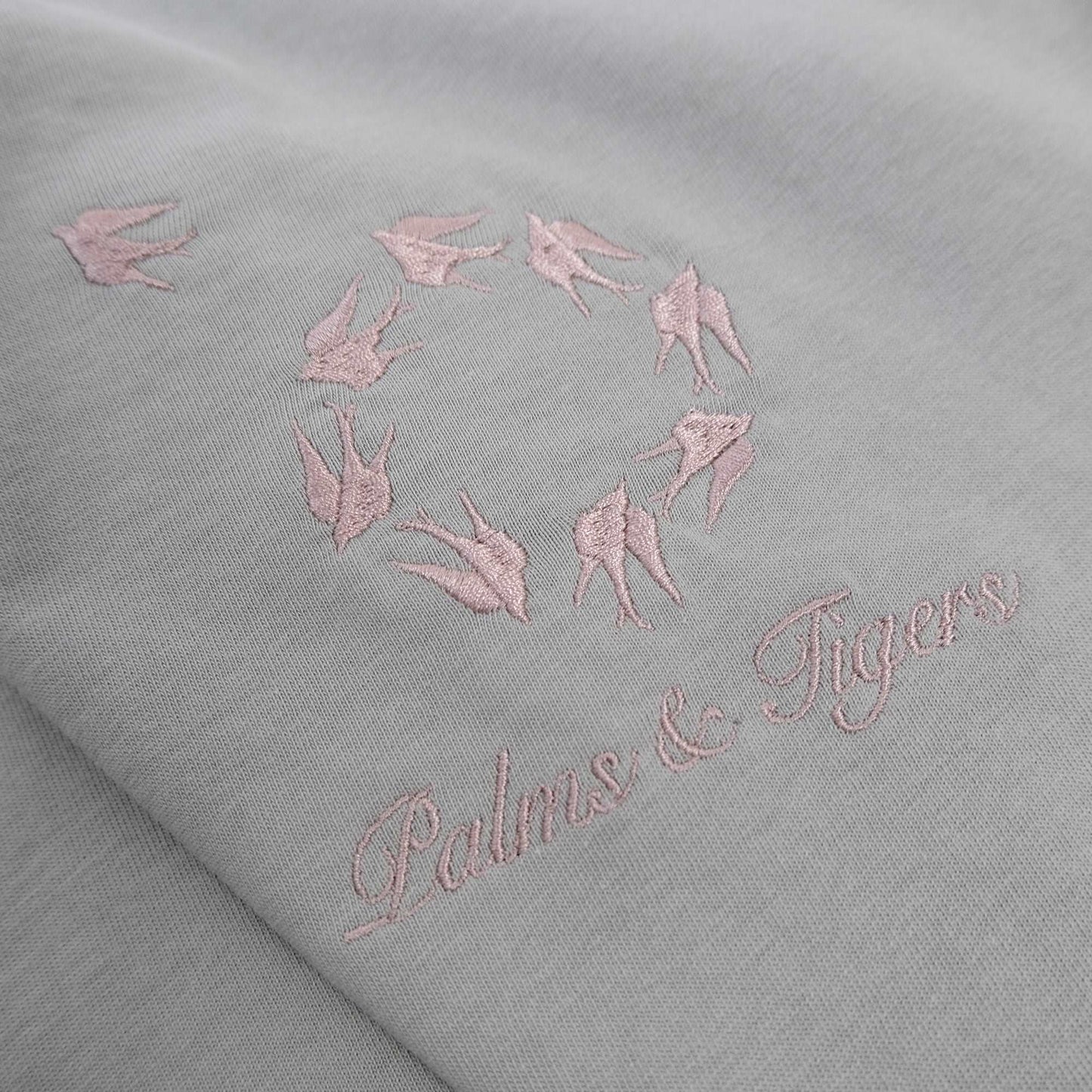 Newer Perspective T- Pink Embroidery Light grey straight-cut T-shirt with pink embroidered birds flying in a circle